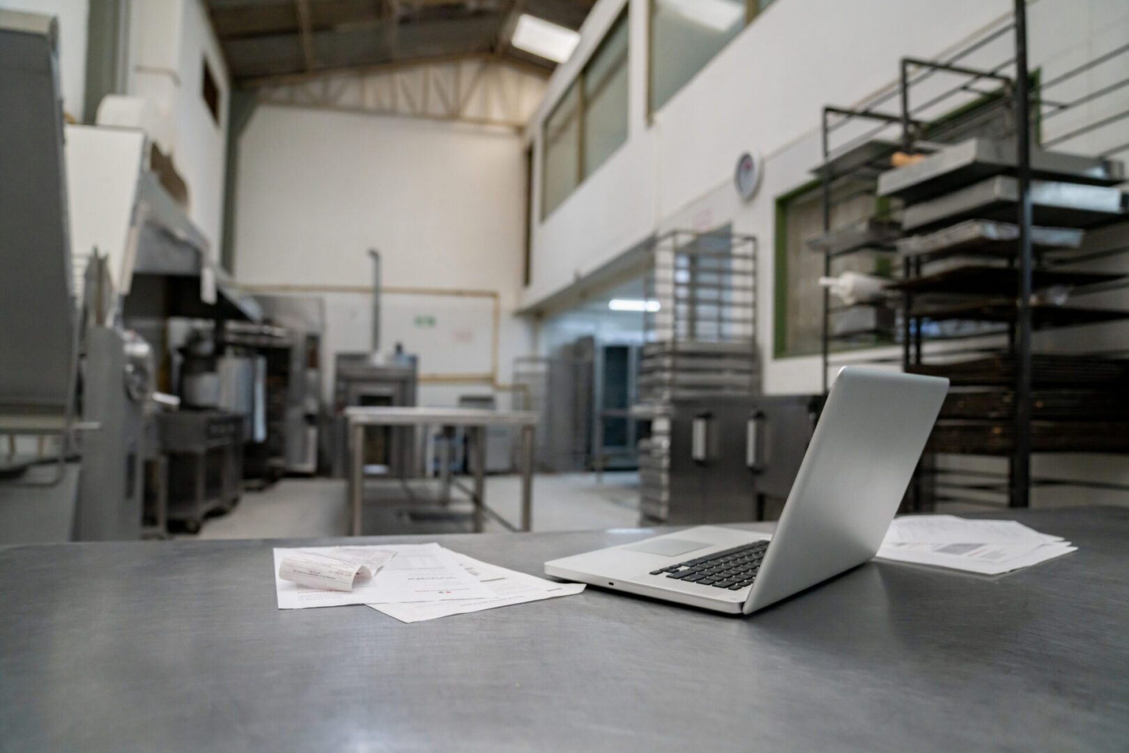 Industrial kitchen workspace with laptop
