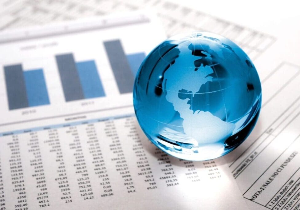 Blue glass globe on financial documents